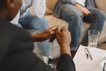 Fototapeta premium Couple at pshycologist appointment sitting in modern office