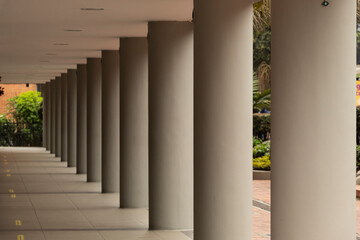 Grey columns of a building in geometric pattern with soft shadow. Architecture and geometric concept