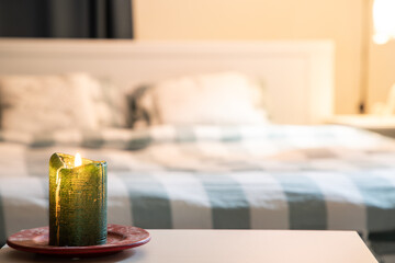cozy bedroom detail focus on burning candle
