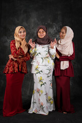 Three modeling of Asian Muslim women when posing in the studio with a textured black oil painting texture.