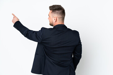 Young Russian business man isolated on white background pointing back with the index finger