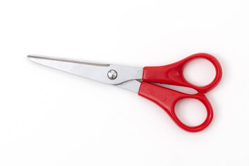 Red scissors isolated on white background.