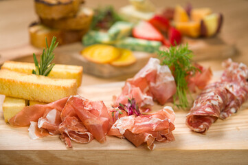 A Charcuterie, or cold cut, platter, at a Whistler restaurant.  Meat, ham, port, salami, pate, cheese, and fruit.