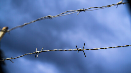 barbed wire against a gloomy sky
