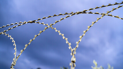 barbed wire against a gloomy sky
