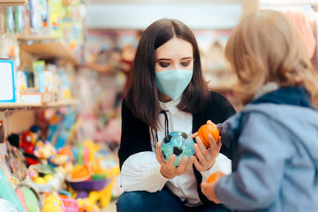 Mother and Toddler Daughter Shopping for Toys in a Store