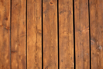 Wooden bright brown planks texture with cracks and screws, straight vertically view