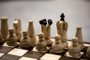 White Chess pieces on board, arranged in incorrect initial position. king is not in his Chessboard...