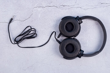 ฺBlack headphones Isolated on Concrete floor background.