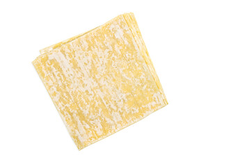 Top view stack of Wonton or Chinese dumpling sheets, image with clipping path, isolated yellow dumpling sheets on white background.