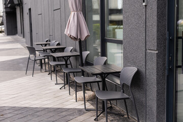 outdoor table and two chairs near the wall at coffee shop,