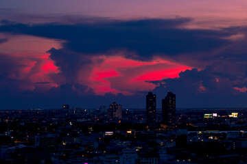 Fototapeta premium The blurred abstract background of the morning sun exposure to the tiny dust particles that surround the tall buildings in the capital, the long-term health issue of pollution
