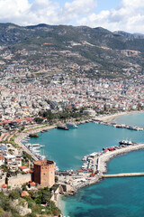 Obraz premium panoramic view to the city of Alanya, marina, sea and mountains from the top of the fortress wall