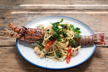 Spaghetti with spicy lobsters in white plate