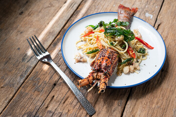 Spaghetti with spicy lobsters in white plate