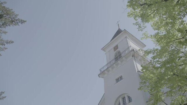 Camera panning along the front of St. Blasius Church in Freiburg, Z&auml;hringen on a spring day