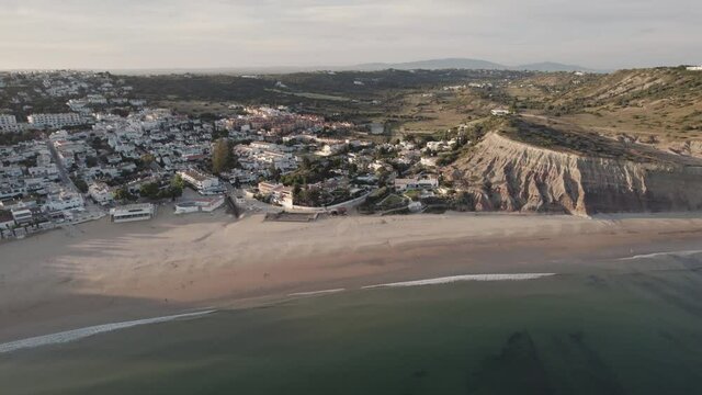 Wide view over deserted Praia da Luz in Algarve coast at dusk. Aerial