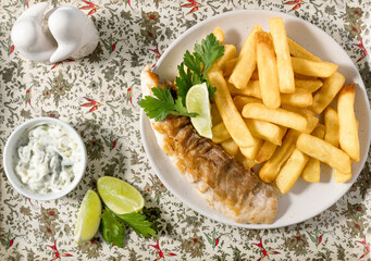 Fish and chips with lemon, parsley and tartar sauce