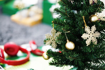 Christmas tree with ornaments and red Wireless headphones on the floor blur background.