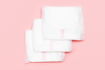 Three female pads on a pink background close-up top view.