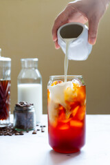 a glass of homemade cold brew coffee with milk