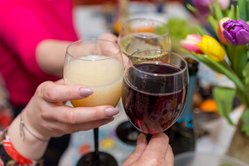Women's hands with glasses of champagne. Hands holding glasses and toasting, happy festive moment.