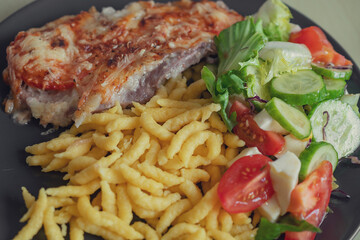 Spaetzle or Spätzle egg noodle pasta with chicken, onions and seasoning. Traditional European cuisine dish (Swabian, German, Austrian, Hungarian). Delicious gluten free Knöpfle bowl. Top view