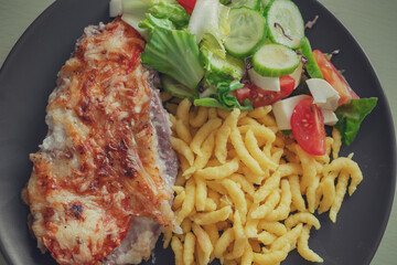 Spaetzle or Spätzle egg noodle pasta with chicken, onions and seasoning. Traditional European cuisine dish (Swabian, German, Austrian, Hungarian). Delicious gluten free Knöpfle bowl. Top view