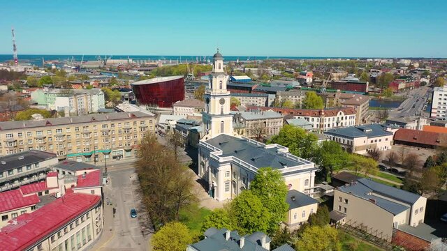 Liepaja, Latvia,Baltics. Beautiful 4K panoramic aerial video from flying drone to Holy Trinity Cathedral, Concert hall Great Amber (Lielais dzintars) and city center, trade channel in spring. (Series)