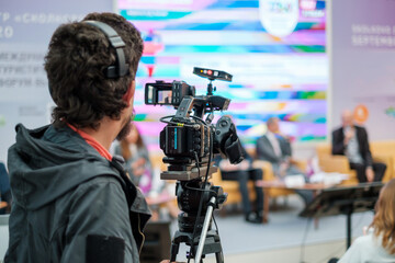 Cameraman shooting video and broadcasting conference