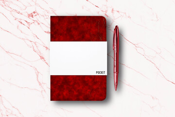 Blank red paper notebook or pocket book and a pen on white marble table background.