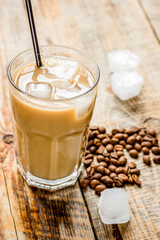 Ice coffee with milk and beans for lunch on stone background