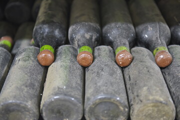 Yalta, Crimea - 10.16.2015 : Wine bottles from the 1940s covered in dust are laid out in the old cellar of the winery.