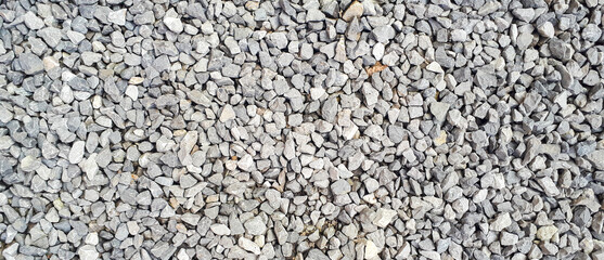 Gravel road texture. Small grey pebble pattern. Stone ground