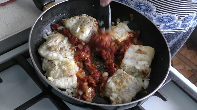 cod fish is fried in a pan. healthy food concept 