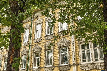 Fototapeta premium Windows with carved platbands of an old wooden house