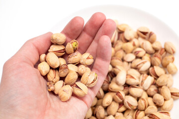 Pistachio nuts on hands. Handful of pistachio nuts