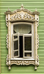 Window with carved platbands of an old wooden house