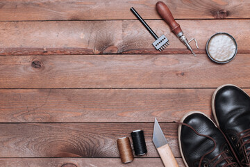 Backdrop of Shoes maker tools on wooden table. Set of Leather crafting tools.