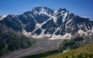 Panoramic view of Glacier Seven on mount Donguzorun. Panoramic view from Cheget mount, Kabardino Balkaria region. Russia. Altitude is 3000 metres. View on Donguzorun peak on left and Nakratau peak on