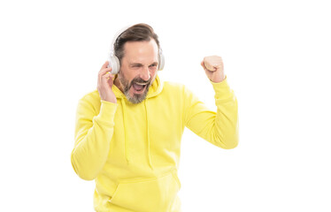 cheerful mature man in hoody listen music or audio book in headphones isolated on white, music.