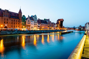 Fototapeta premium Gdansk night city riverside view. View on famous crane and facades of old medieval houses