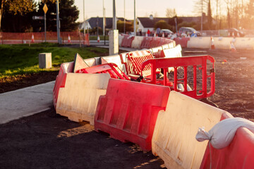 Red and white barriers on a road repair site to constrain public movement for their safety....