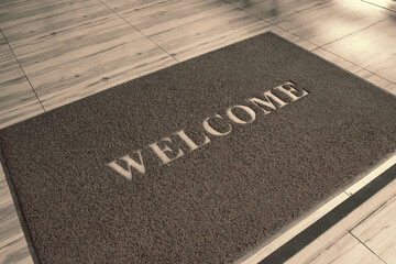 Welcome mat on wooden floor.