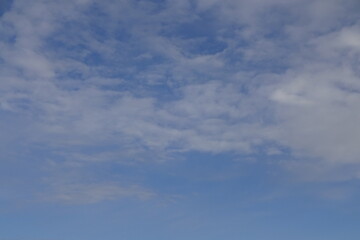 The blue sky with white clouds. Background or backdrop.