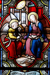 Cordeliers church.  Stained glass window.  The Annunciation is the announcement by the angel Gabriel to the Virgin Mary that she will become the mother of Jesus.  Lons le Saunier. France.