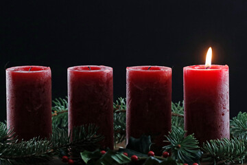 Natural advent wreath or crown with one burning red candle.  Christmas composition. .. France.