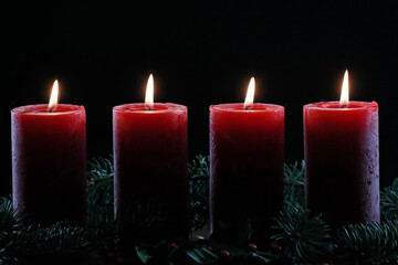 Natural advent wreath or crown with four burning red candles.  Christmas composition. .. France.