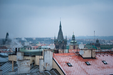 Fototapeta premium first snow on the rooftops of the center of Prague top view