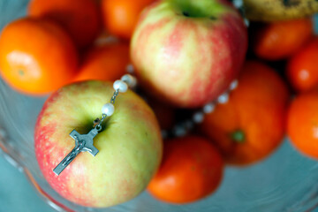 Prayer beads with crucifix on apples. Religious symbols.  France.